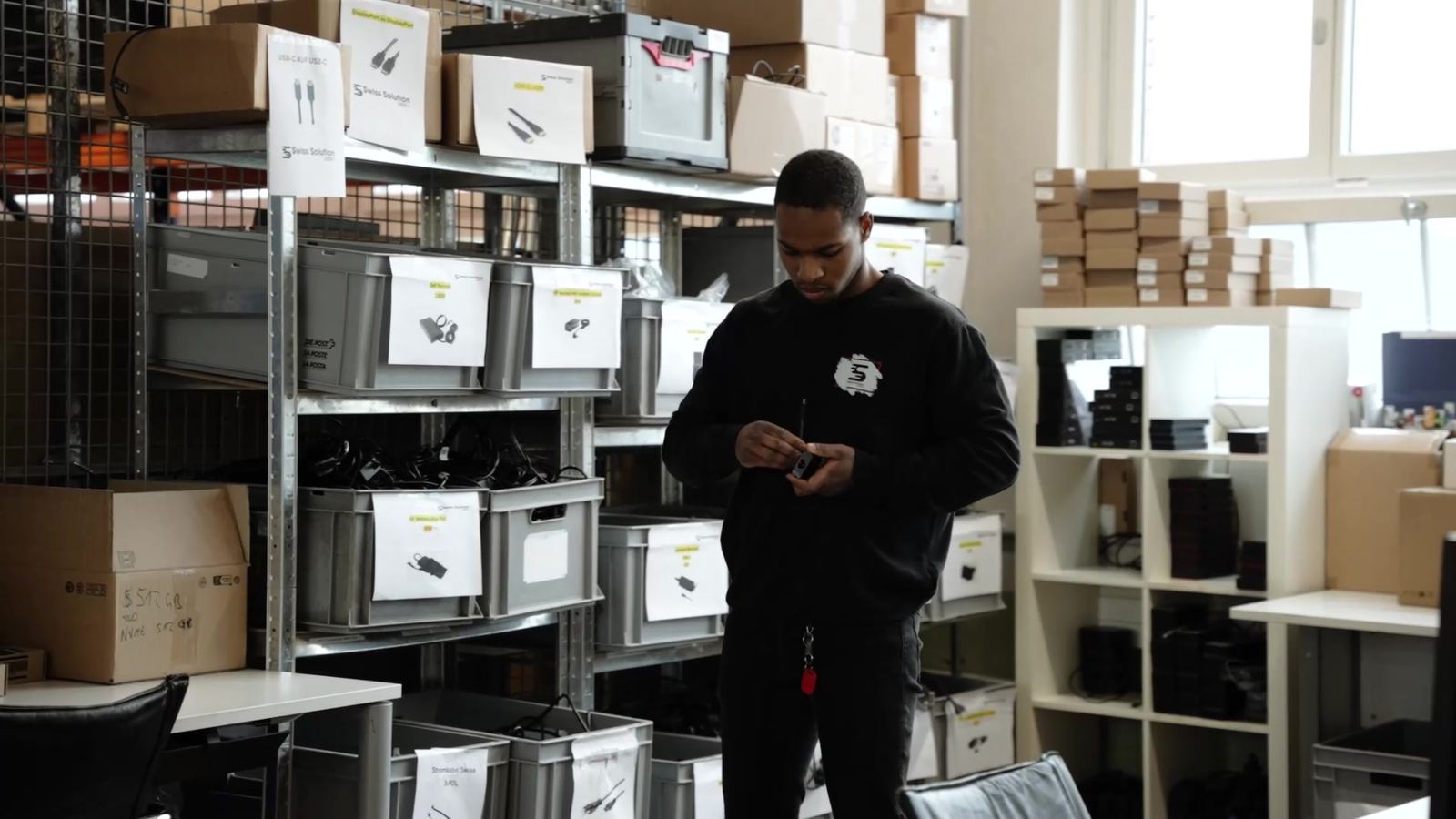 An employee scans devices in the warehouse