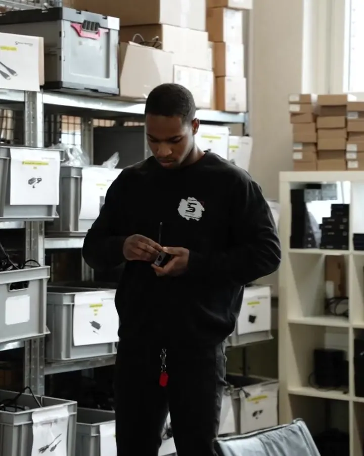 Un collaborateur saisit un appareil avec le scanner portable dans l’entrepôt